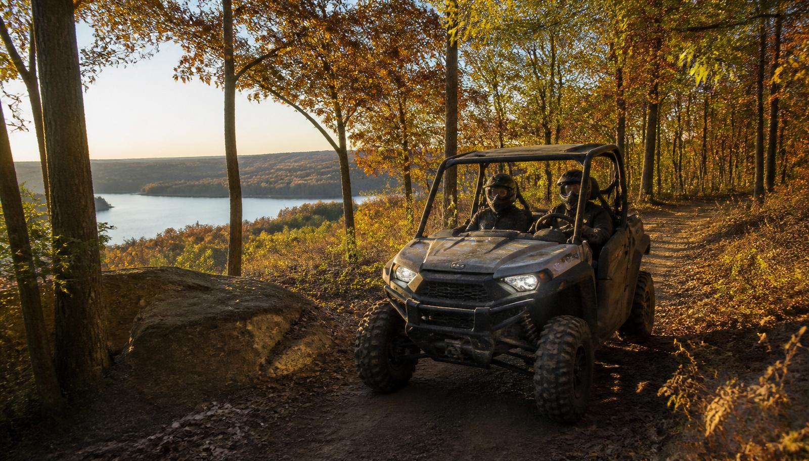 UTV on a wooded Wisconsin trail overlooking a lake in autumn